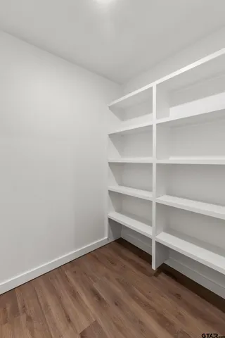 a view of a room with wooden floor and a window