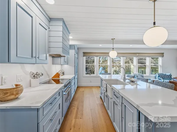 a view of living room with kitchen island furniture and a chandelier