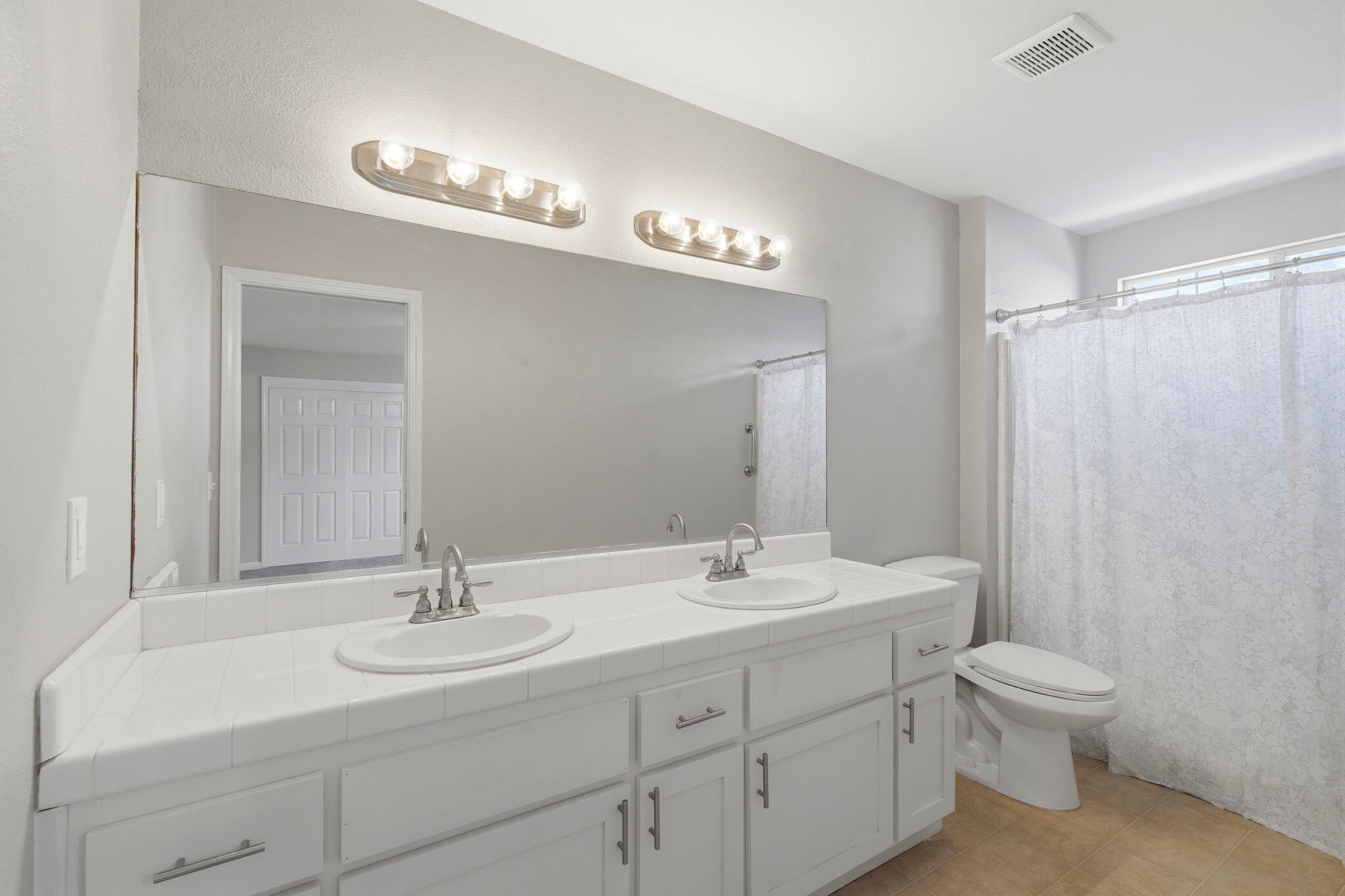 481 Katelyn Court Exeter, CA 93221 - Photo 19 of 33 a bathroom with a double vanity sink mirror and toilet