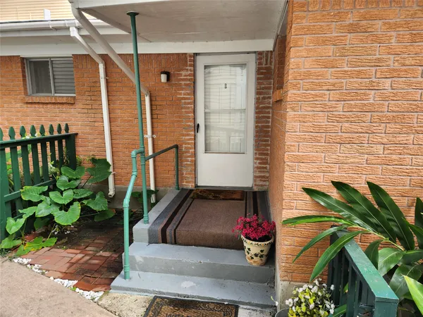 a view of a porch with potted plants