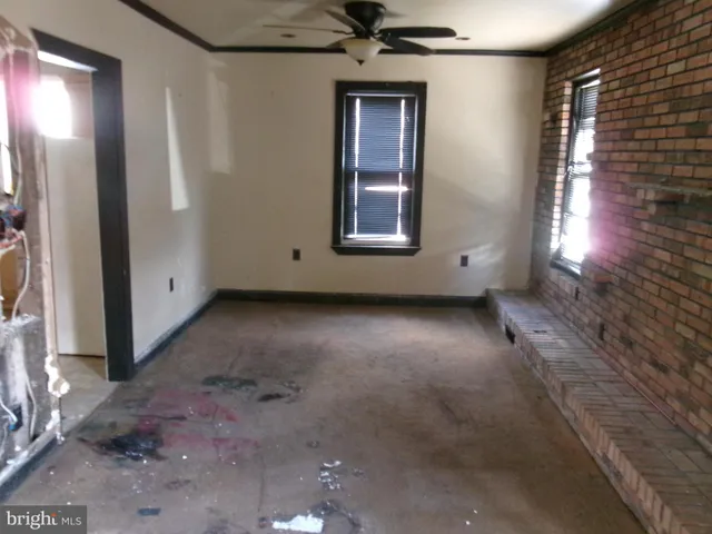 a view of a livingroom with a ceiling fan and window