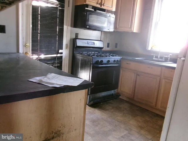 a kitchen with a stove and a microwave