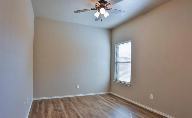 a view of a room with wooden floor and closet