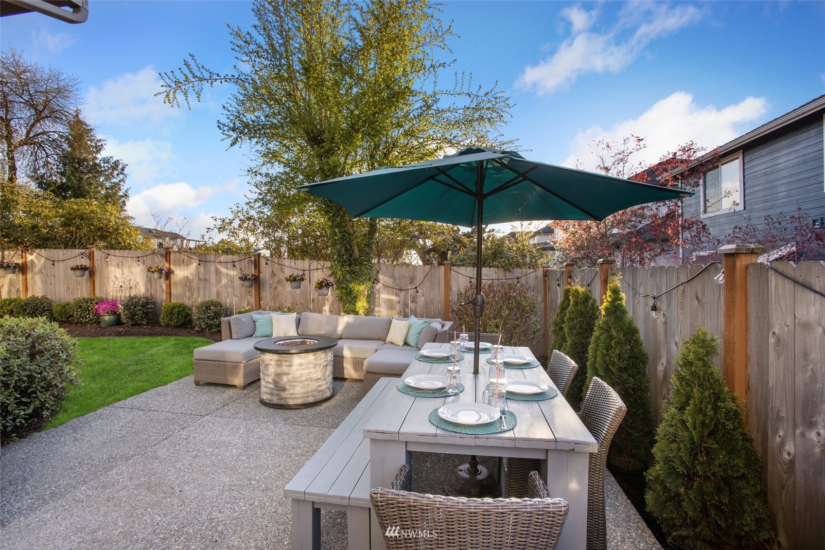 1328 North 39th Street Renton, WA 98056 - Photo 31 of 40 a view of a patio with table and chairs potted plants with wooden fence