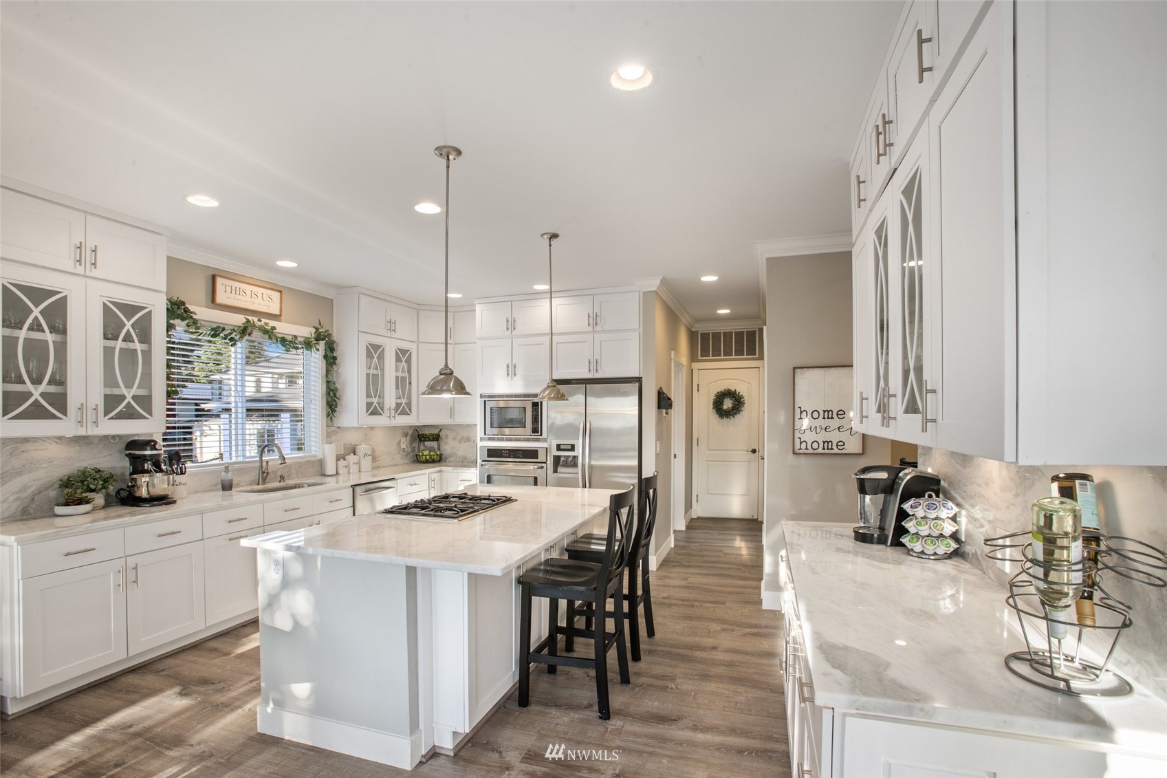 1328 North 39th Street Renton, WA 98056 - Photo 10 of 40 a kitchen with stainless steel appliances kitchen island granite countertop a sink and cabinets