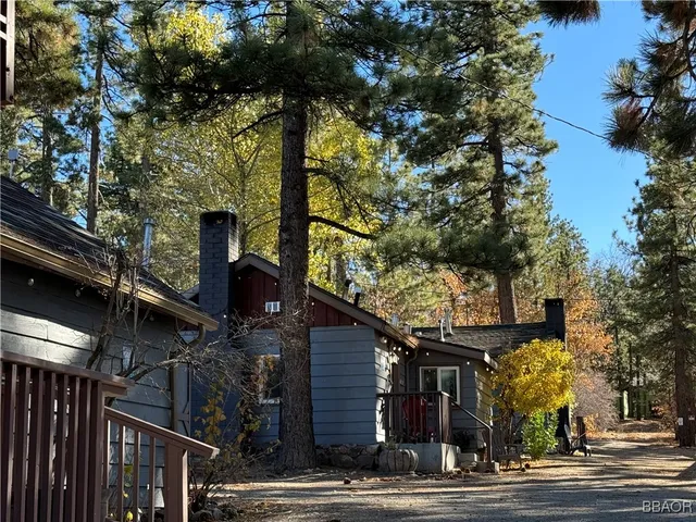a bedroom with bed and wooden floor