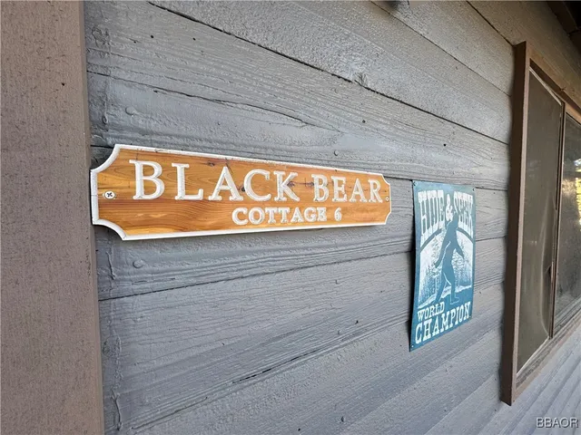 a bedroom with a bed and a flat tv screen on the dresser