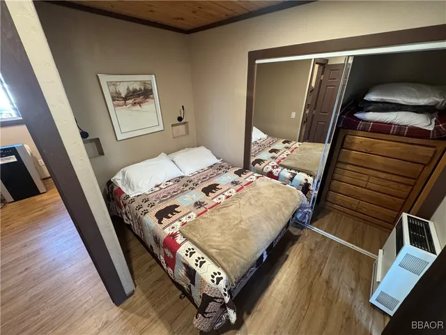 a bed sitting in a bedroom next to a window