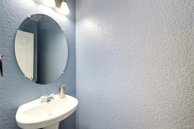 a bathroom with a sink and mirror