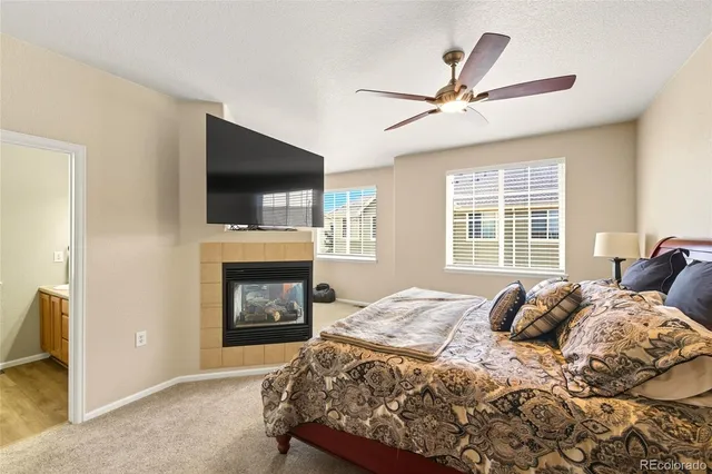 a bedroom with a bed and a fireplace