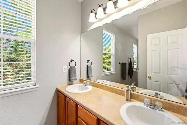 a bathroom with a sink a vanity and a mirror