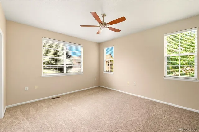 a view of a livingroom with a ceiling fan and window