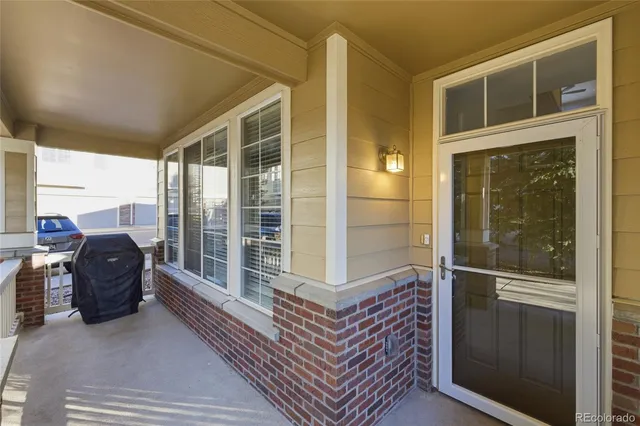a balcony with furniture and a floor to ceiling window