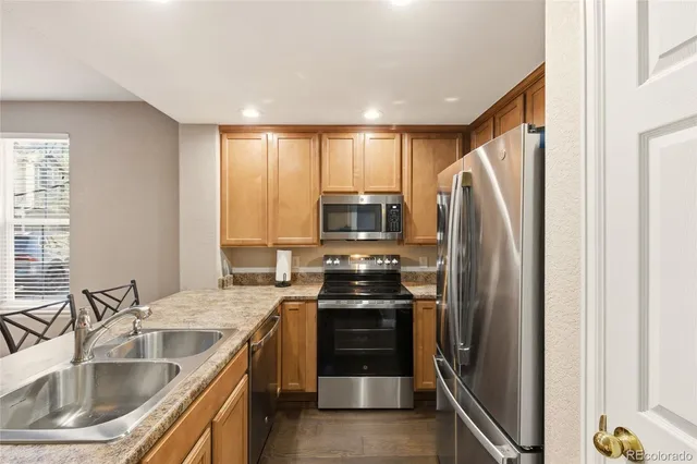 a kitchen with a sink stove and refrigerator