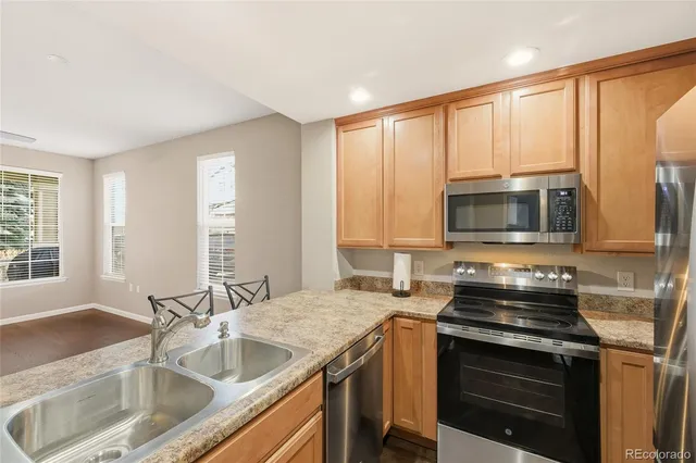 a kitchen with a sink stove and microwave