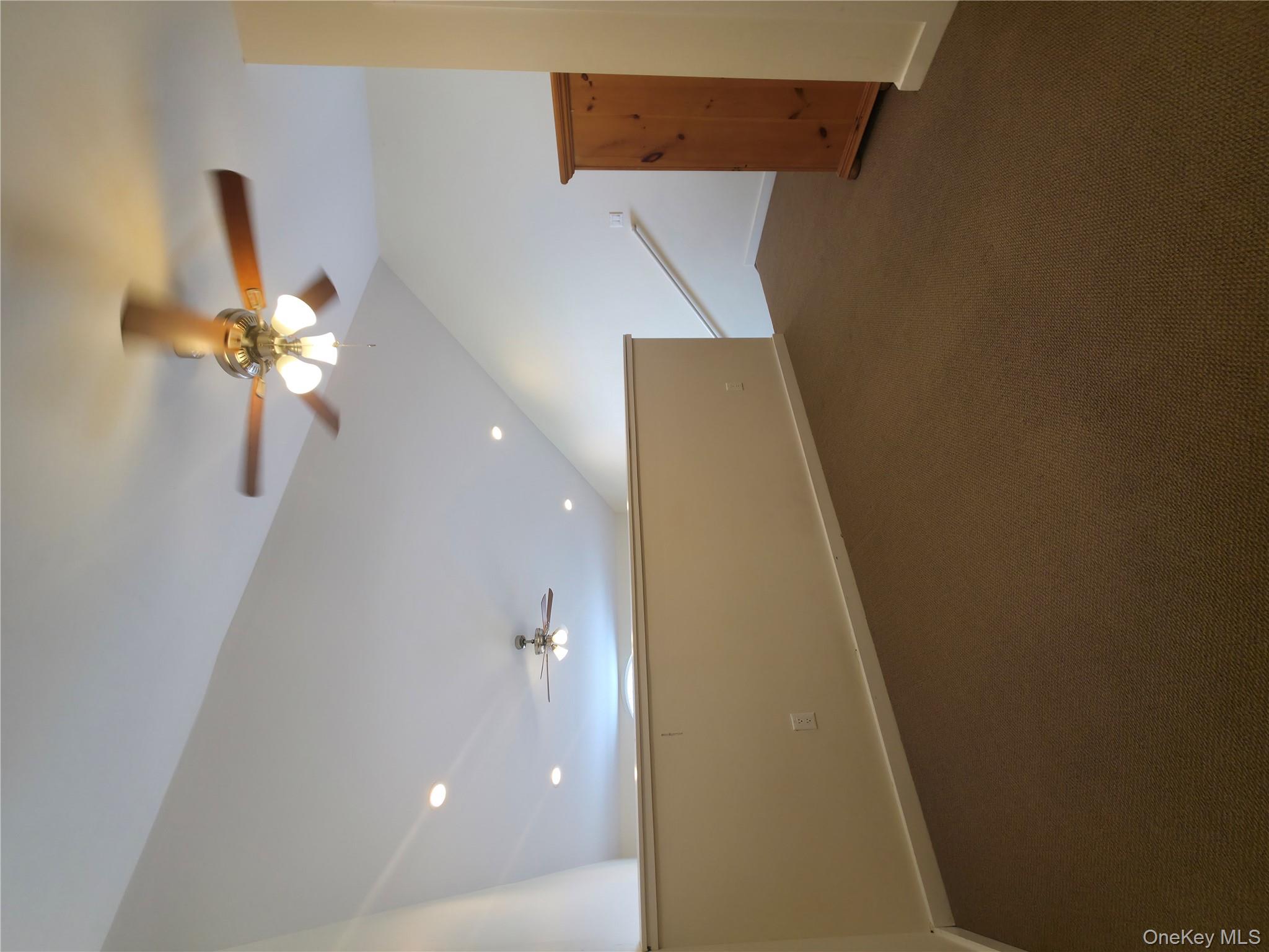 231 Reynolds Road, Unit 9 Fallsburg, NY 12759 - Photo 12 of 15 Bonus room with a ceiling fan, lofted ceiling, baseboards, and dark colored carpet