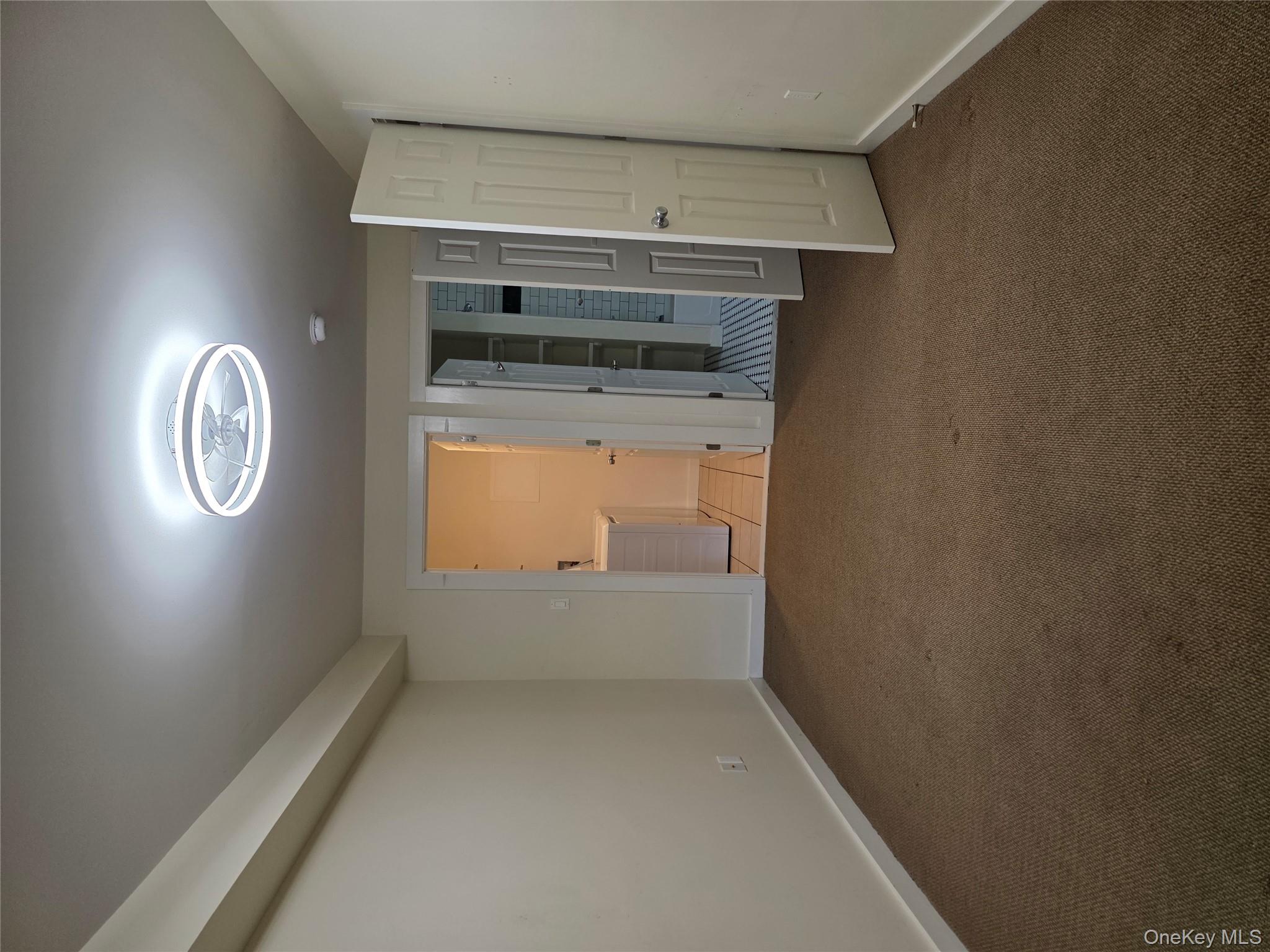 231 Reynolds Road, Unit 9 Fallsburg, NY 12759 - Photo 8 of 15 Unfurnished bedroom featuring connected bathroom, carpet floors, and washer and clothes dryer