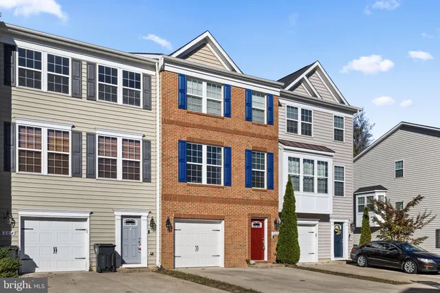 a front view of a house with a tree