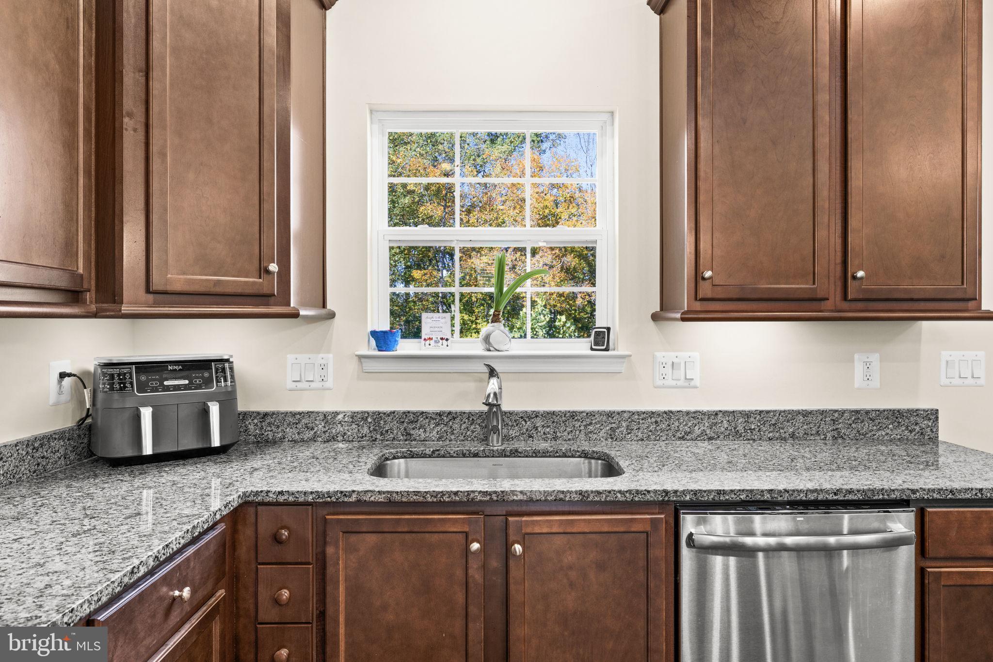 302 Tree Line Drive Fredericksburg, VA 22405 - Photo 21 of 38 a kitchen with granite countertop cabinets sink and window