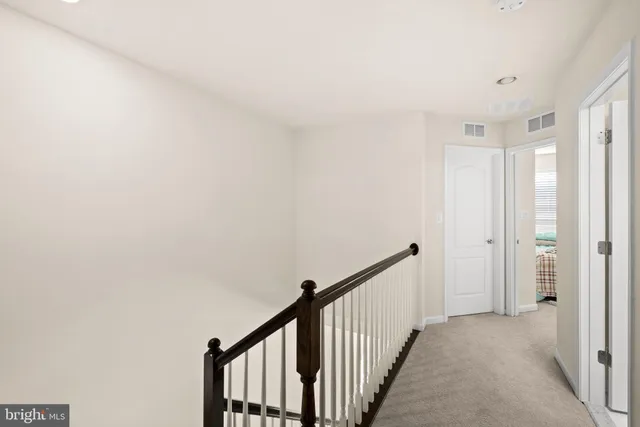 a view of a hallway with wooden floor and entryway