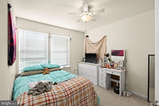 a bedroom with a bed dresser and a window
