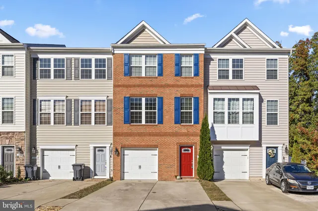 a view of a white house with large windows