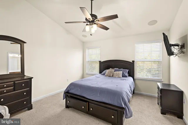 a bedroom with a bed dresser and a window