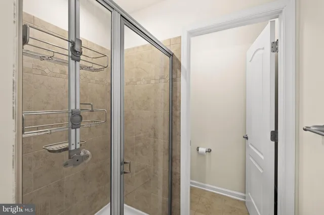 a bathroom with a glass shower door