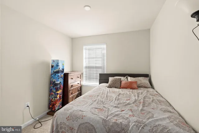 a bedroom with a large bed and a flat tv screen on a dresser