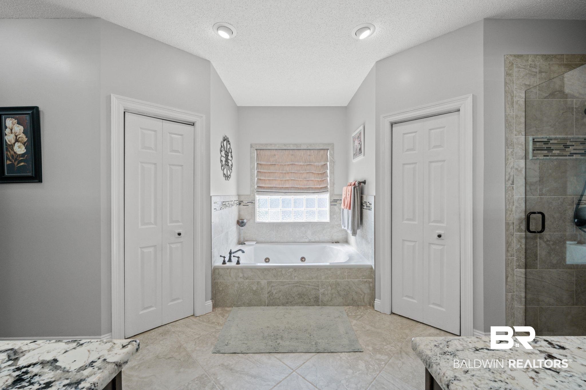 3100 Radcliff Road Saraland, AL 36571 - Photo 32 of 65 Full bath featuring a shower stall, a closet, and a whirlpool tub