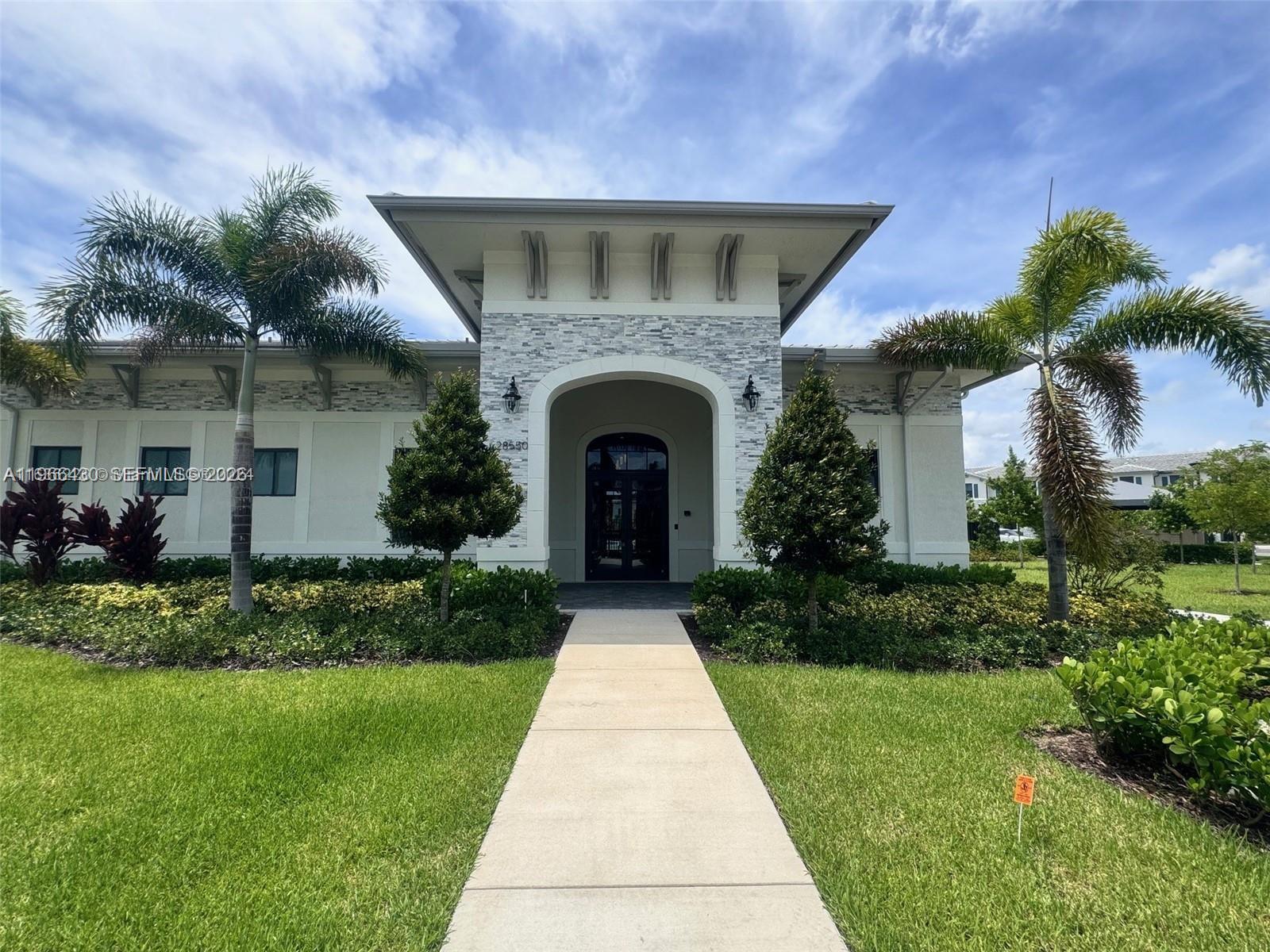 13300 Southwest 286th Street Homestead, FL 33033 - Photo 34 of 48 a front view of a house with garden