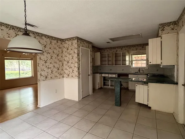 a kitchen with stainless steel appliances kitchen island granite countertop a refrigerator and a stove top oven