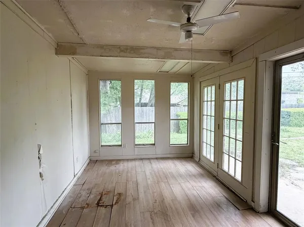 a view of hallway with a large window and wooden floor