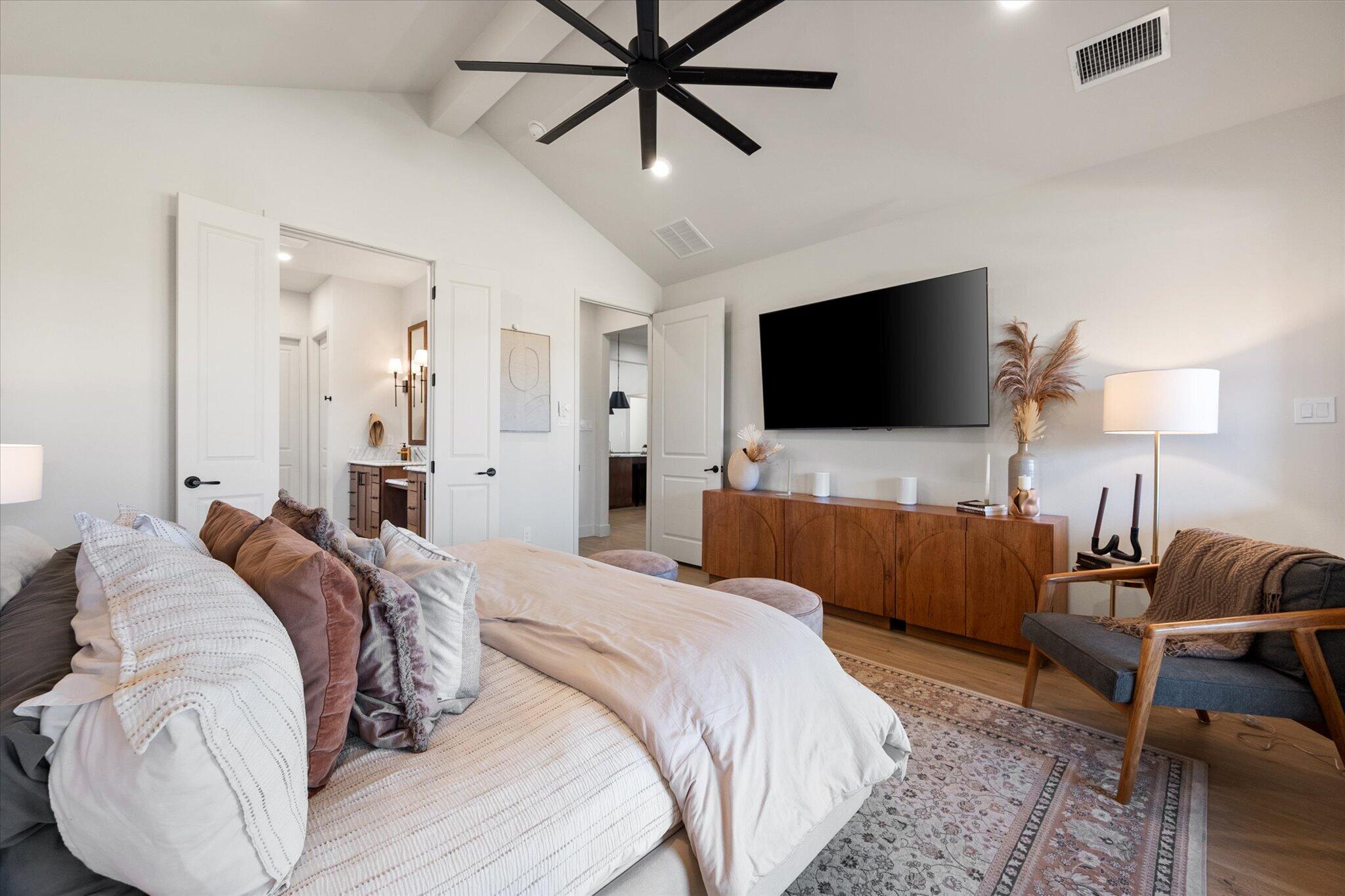 4026 136th Street Lubbock, TX 79423 - Photo 31 of 40 a bedroom with a bed and a flat screen television