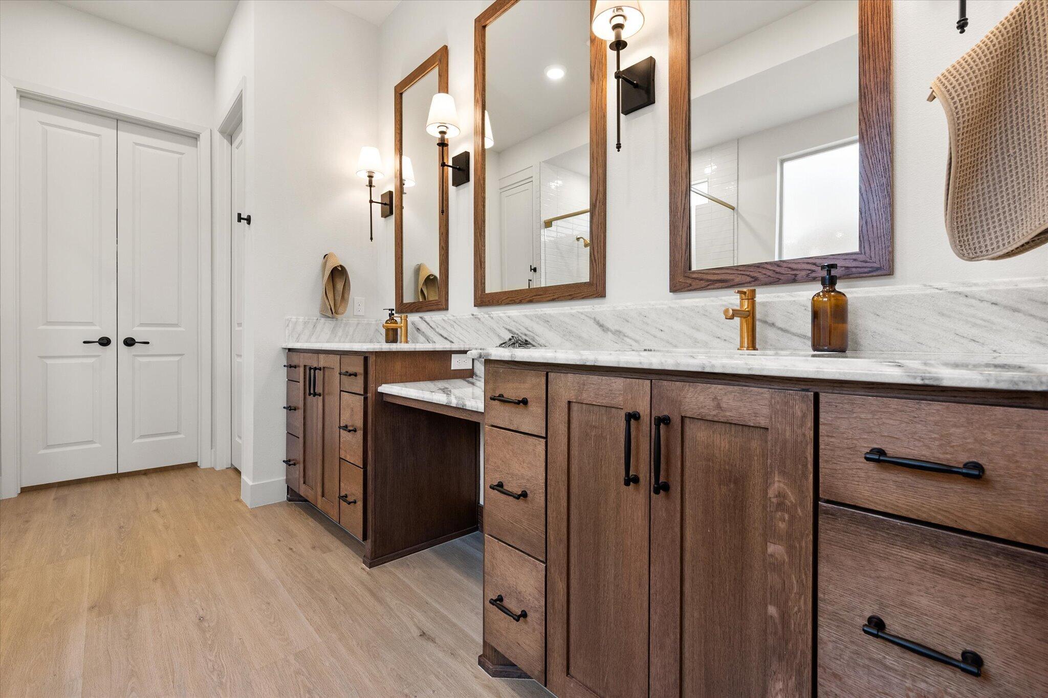 4026 136th Street Lubbock, TX 79423 - Photo 32 of 40 a spacious bathroom with a granite countertop sink a mirror and shower