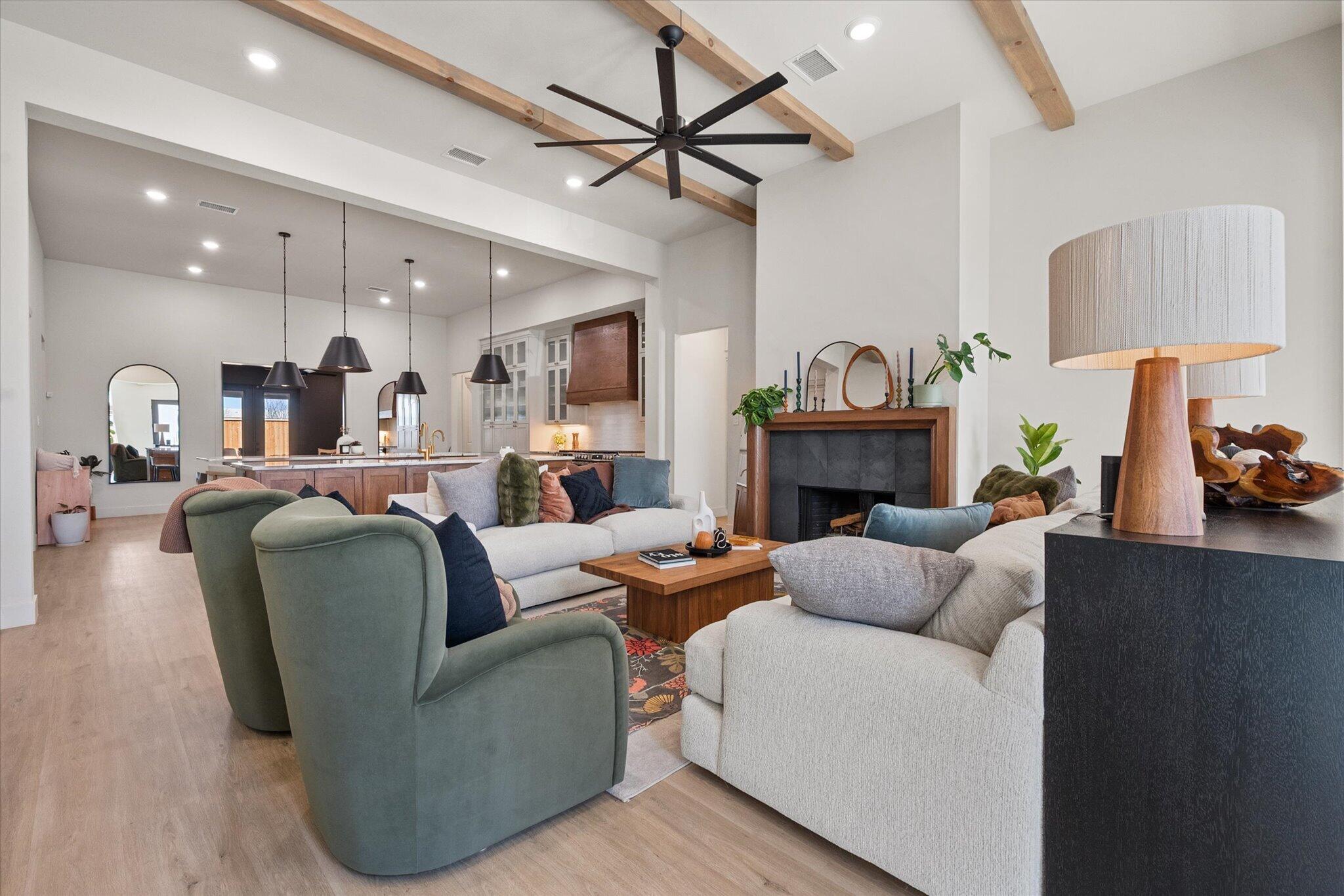 4026 136th Street Lubbock, TX 79423 - Photo 5 of 40 a living room with furniture a fireplace and a chandelier