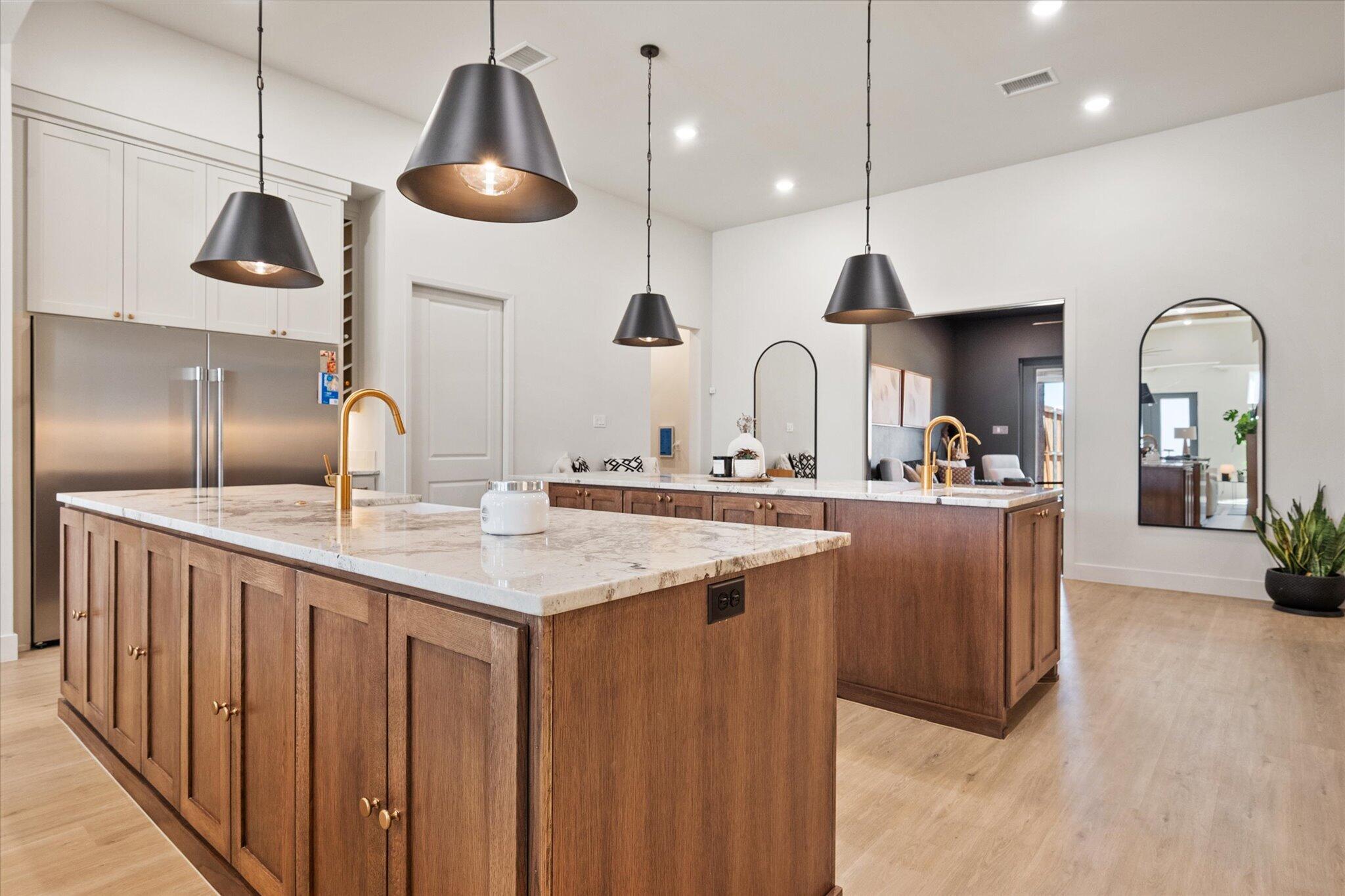4026 136th Street Lubbock, TX 79423 - Photo 9 of 40 a kitchen with stainless steel appliances a sink a center island a stove and cabinets