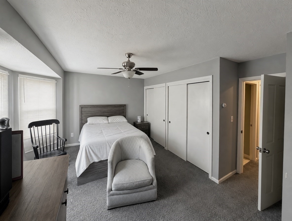 700 2nd Street, Unit 110 Fall River, MA 02721 - Photo 7 of 17 a bedroom with a bed and chair