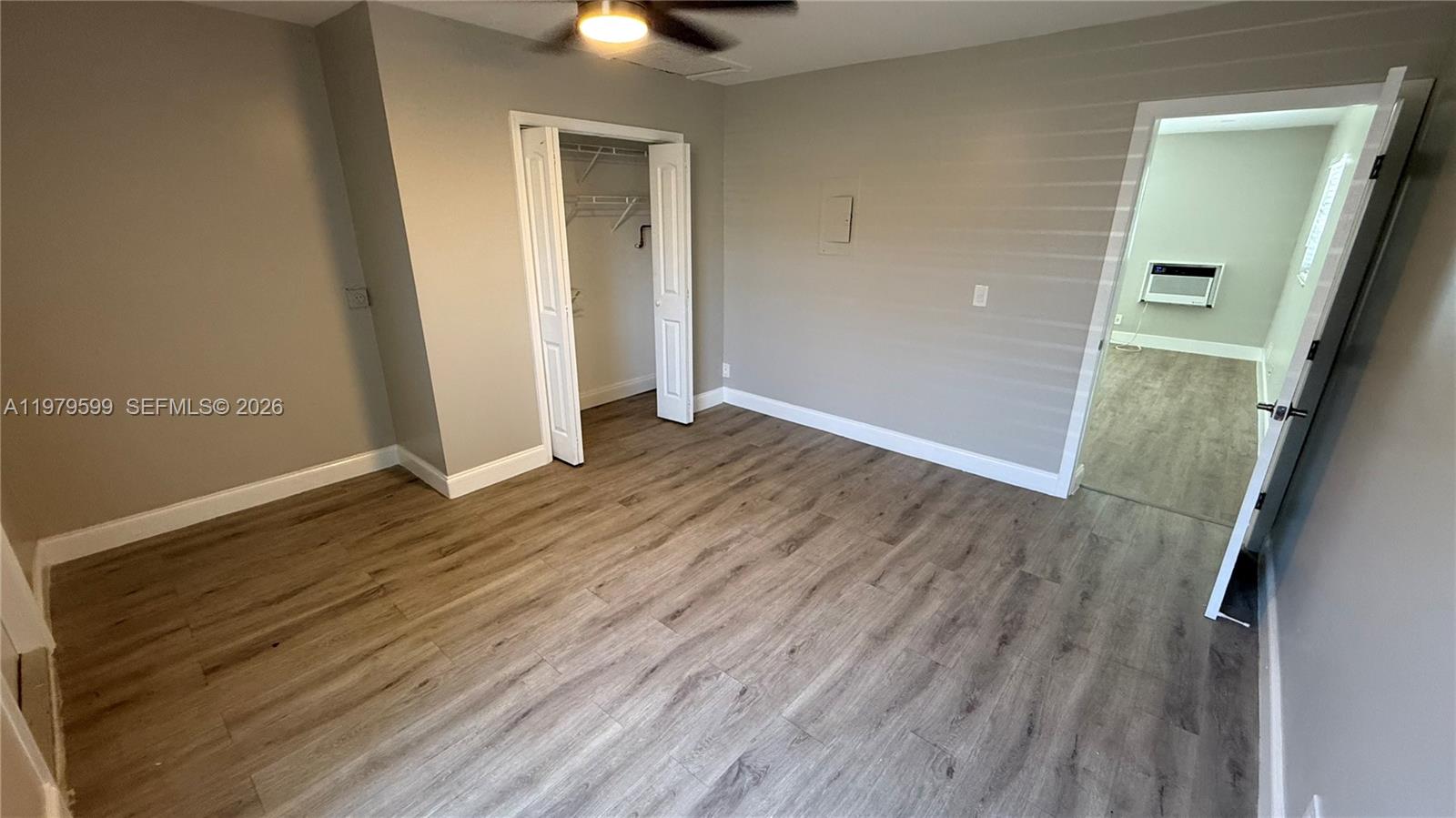 220 Northwest 12th Street, Unit 14 Pompano Beach, FL 33060 - Photo 13 of 19 an empty room with wooden floor and windows