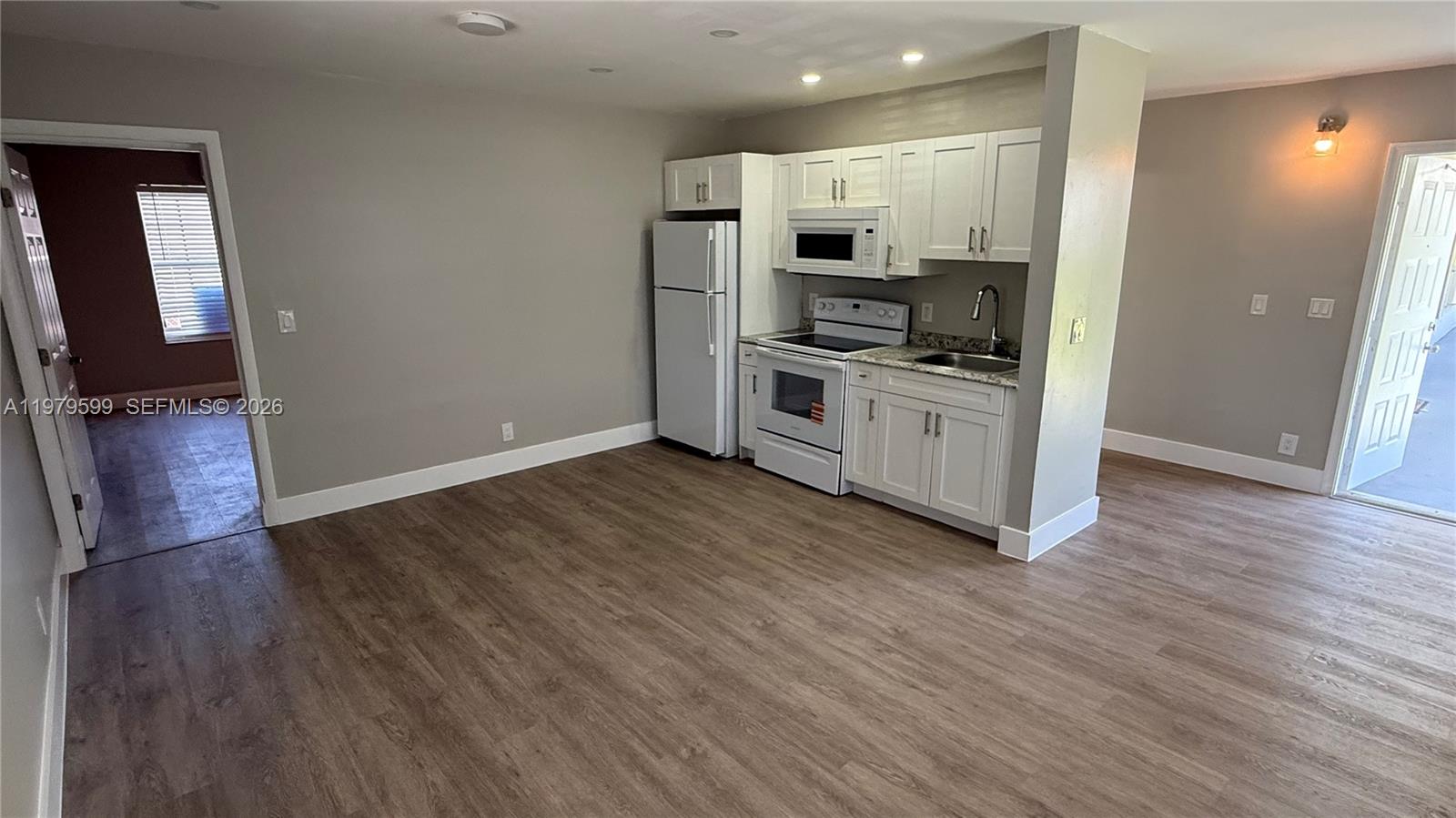 220 Northwest 12th Street, Unit 14 Pompano Beach, FL 33060 - Photo 6 of 19 a kitchen with stainless steel appliances a refrigerator and a stove top oven