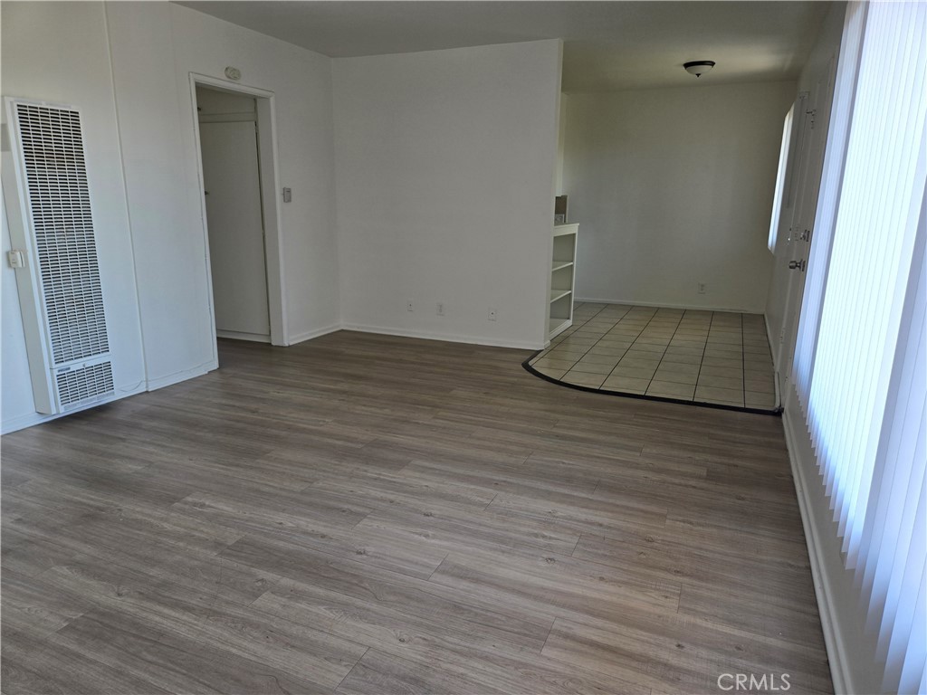 1834 Pine Avenue, Unit 5 Long Beach, CA 90806 - Photo 4 of 11 a view of an empty room with wooden floor and a window