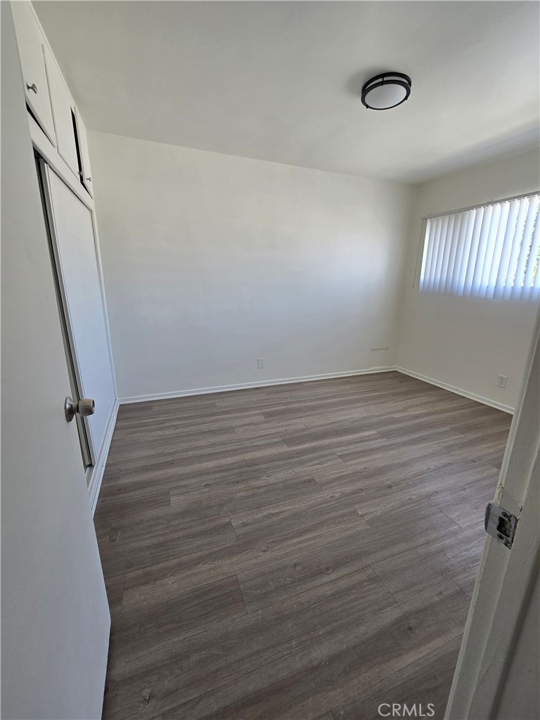 1834 Pine Avenue, Unit 5 Long Beach, CA 90806 - Photo 9 of 11 wooden floor in an empty room with a window