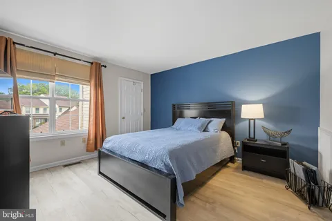 a spacious bedroom with a bed and a large window