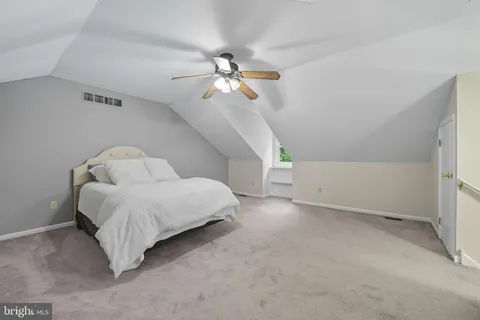a living room with furniture and a ceiling fan