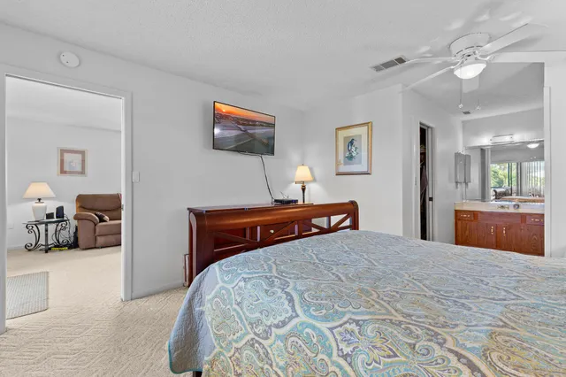 a bedroom with a large bed and a chandelier