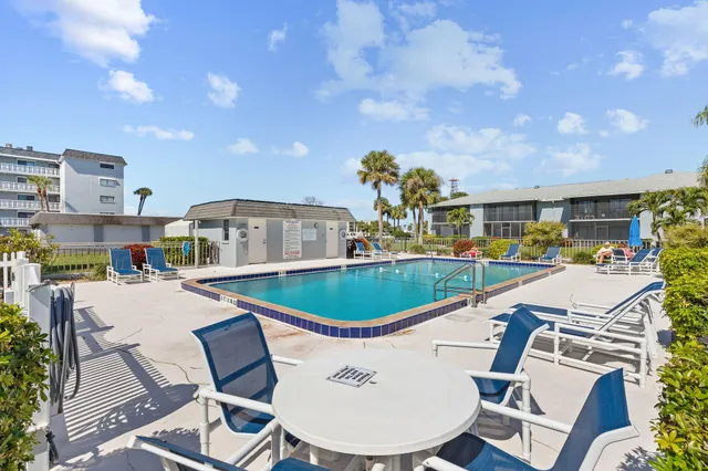 a view of a swimming pool and lounge chairs