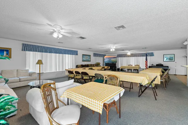 a living room with lots of furniture and a large window