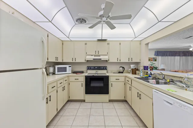 a kitchen with stainless steel appliances granite countertop a sink and cabinets