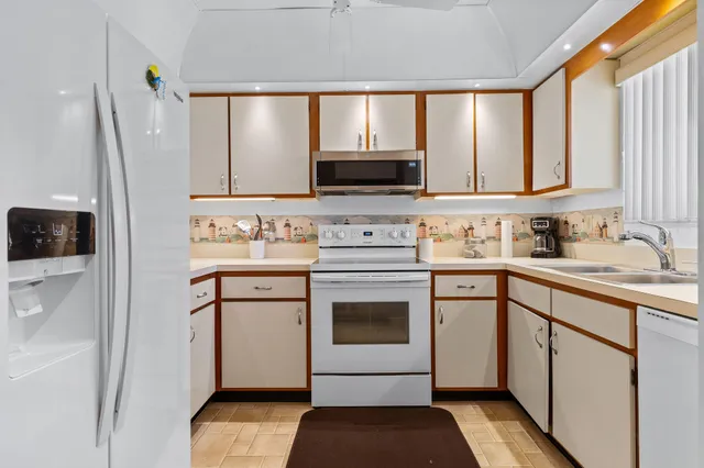 a kitchen with a stove a sink and a microwave