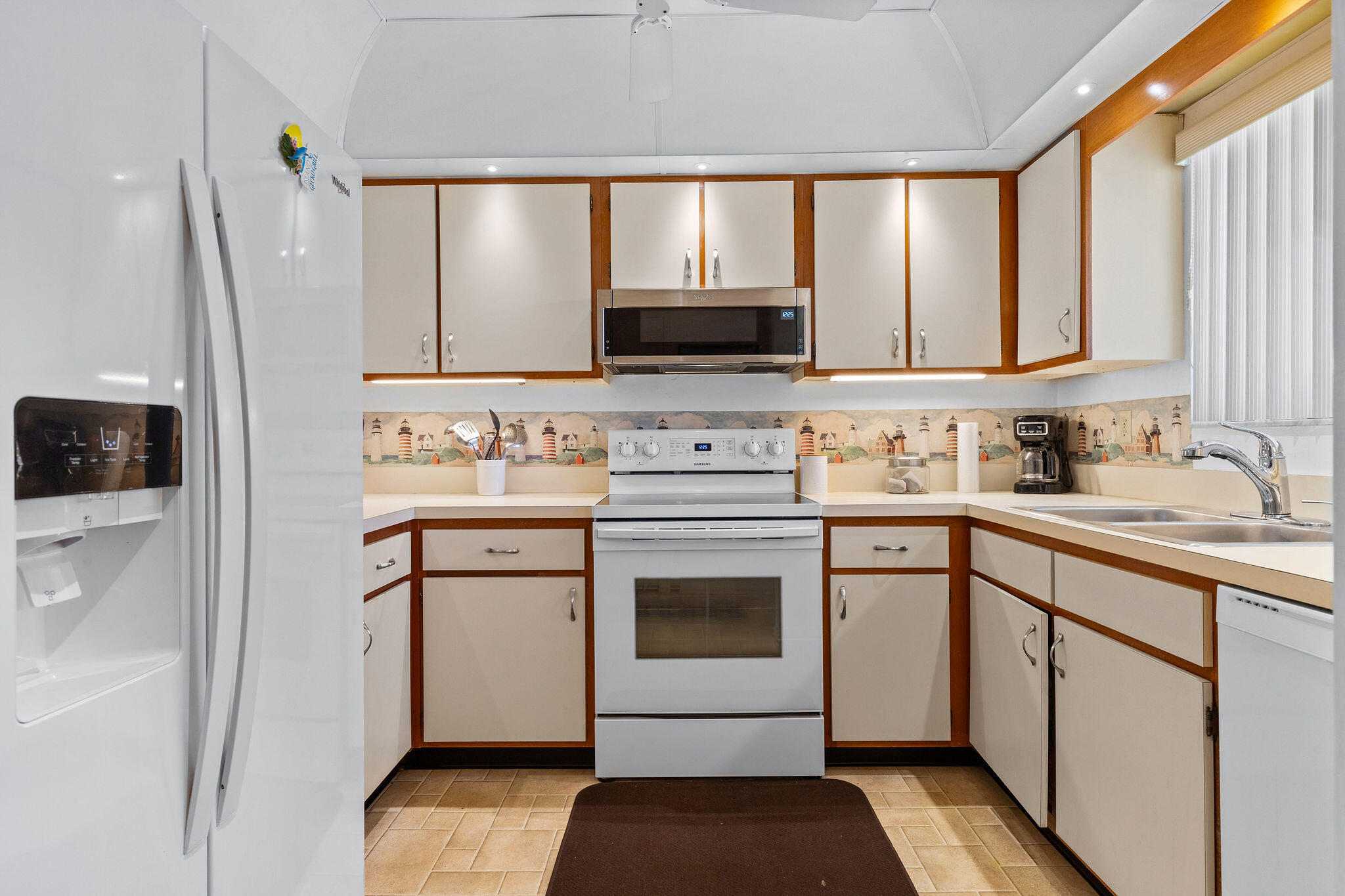 3799 South Banana River Boulevard, Unit 512 Cocoa Beach, FL 32931 - Photo 8 of 34 a kitchen with a stove a sink and a microwave